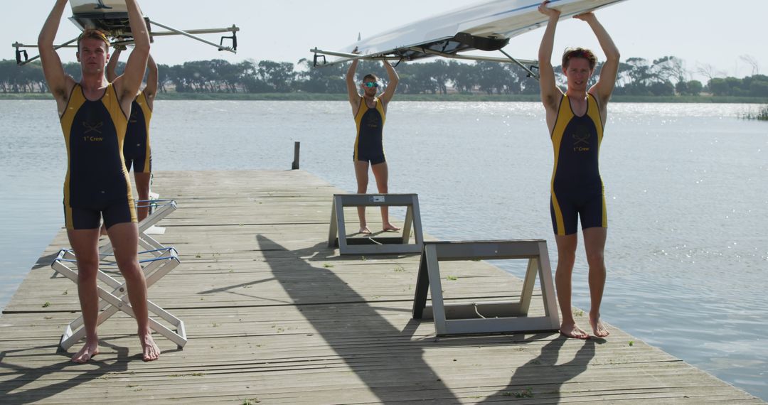 Team of young rowers carrying boat on pier preparing for training - Free Images, Stock Photos and Pictures on Pikwizard.com