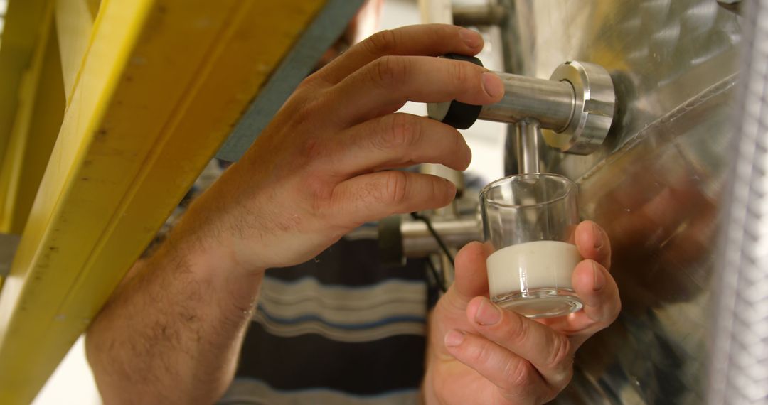 Man Pouring Fresh Milk from Industrial Tank into Glass - Free Images, Stock Photos and Pictures on Pikwizard.com