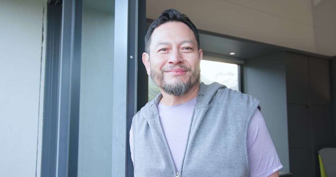 Asian Man Relaxing by Home Doorway in Modern Interior