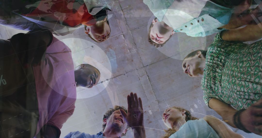 Below View of Diverse Team United in Data-Driven Collaboration Meeting