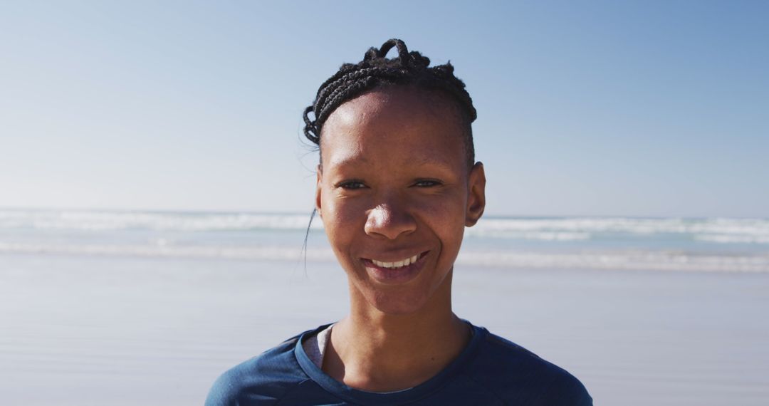 Joyful Woman Practicing Yoga at Ocean Beach on Sunny Day