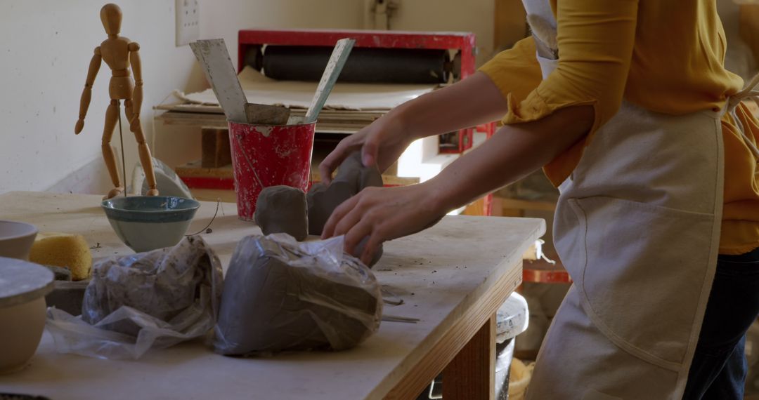 Artist Preparing Clay for Pottery in Studio - Free Images, Stock Photos and Pictures on Pikwizard.com