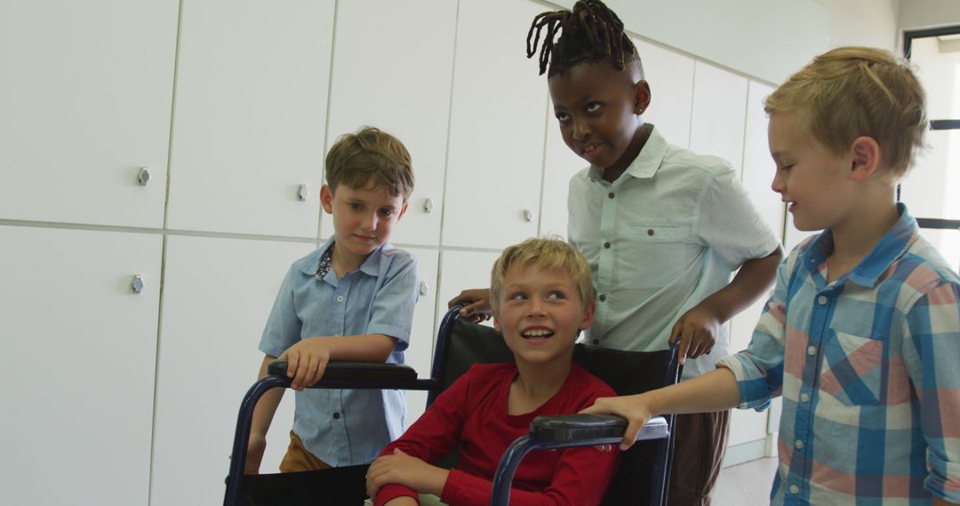 Diverse Children Interacting in School, Smiling and Pushing Wheelchair - Free Images, Stock Photos and Pictures on Pikwizard.com