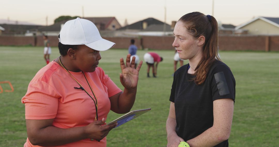 Female Coach Giving Instructions to Young Athlete on Field - Free Images, Stock Photos and Pictures on Pikwizard.com