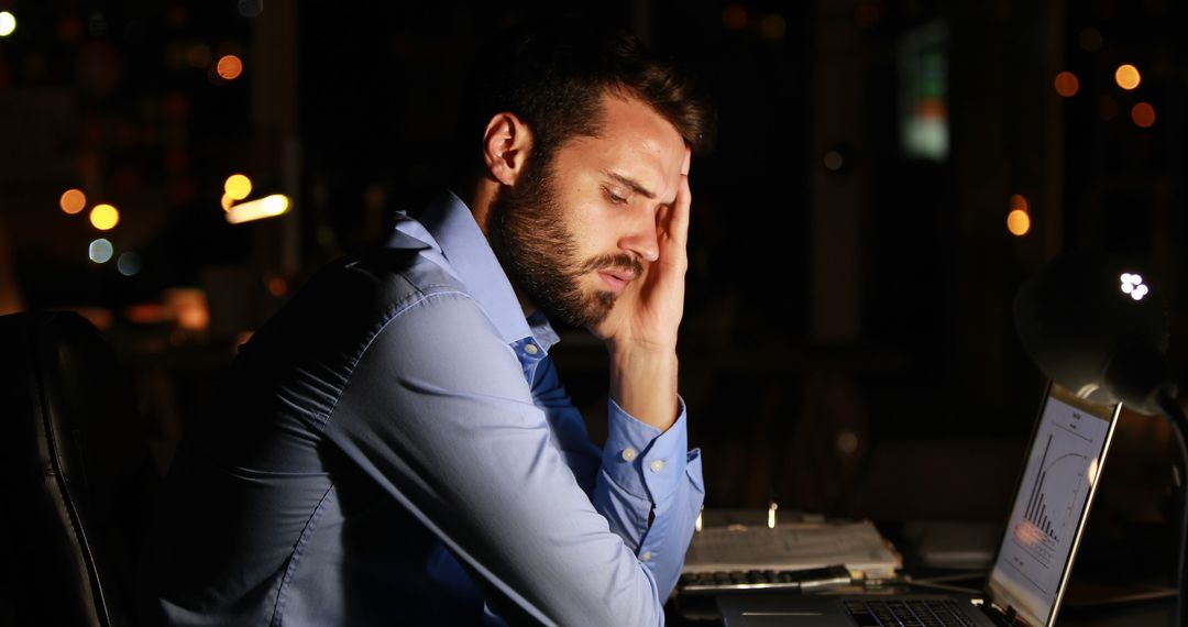 Tired Businessman Stressing Over Laptop in Office at Night - Free Images, Stock Photos and Pictures on Pikwizard.com