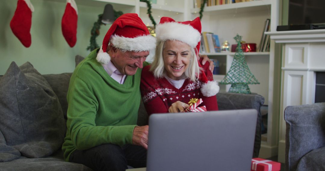 Senior couple video calling during Christmas holiday with gifts and festive decorations - Free Images, Stock Photos and Pictures on Pikwizard.com