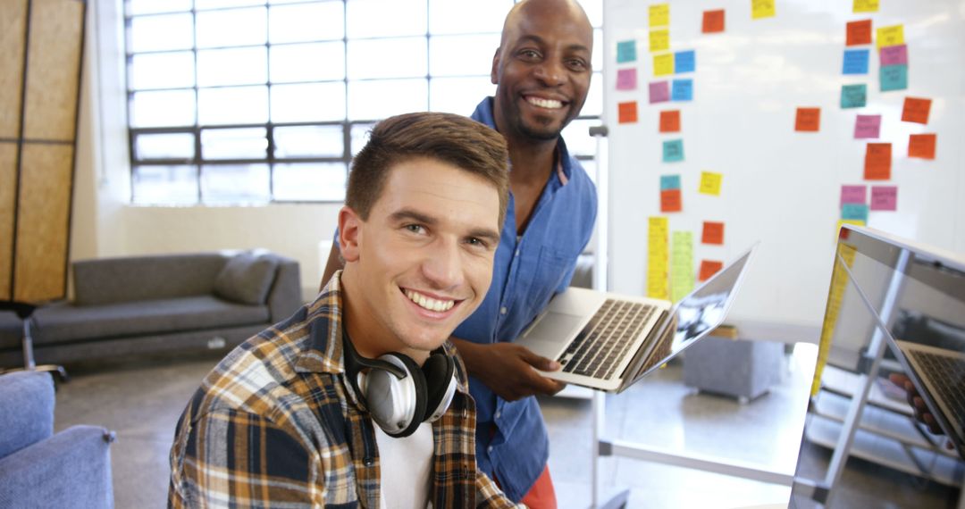 Diverse Colleagues Smiling in Modern Office Workspace - Free Images, Stock Photos and Pictures on Pikwizard.com