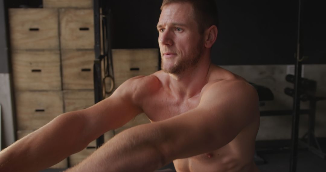 Shirtless Man Engaging CrossFit Training with Box Jump Exercise