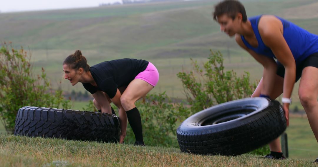 Dedicated athletes performing tire flips during outdoor strength training - Free Images, Stock Photos and Pictures on Pikwizard.com