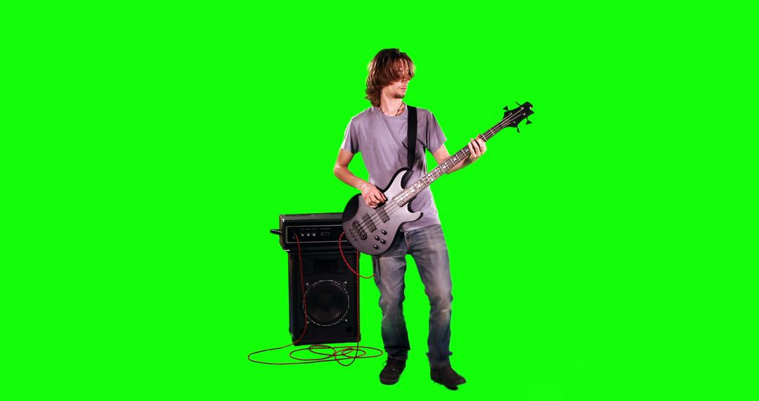 Young Man Playing Electric Bass Guitar in Studio - Free Images, Stock Photos and Pictures on Pikwizard.com