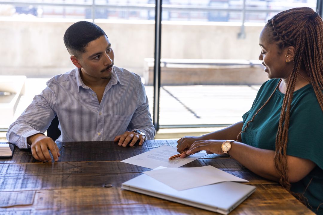 Diverse Team Collaborating on Business Document at Office Table