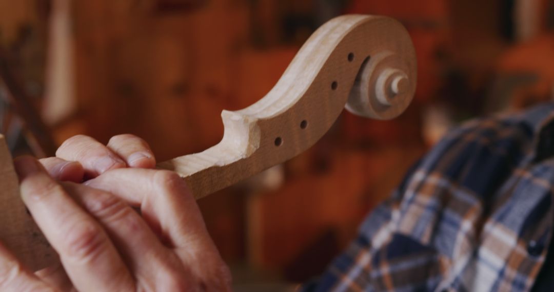 Close-Up of Craftsperson Carving Wooden Violin Neck in Workshop - Free Images, Stock Photos and Pictures on Pikwizard.com