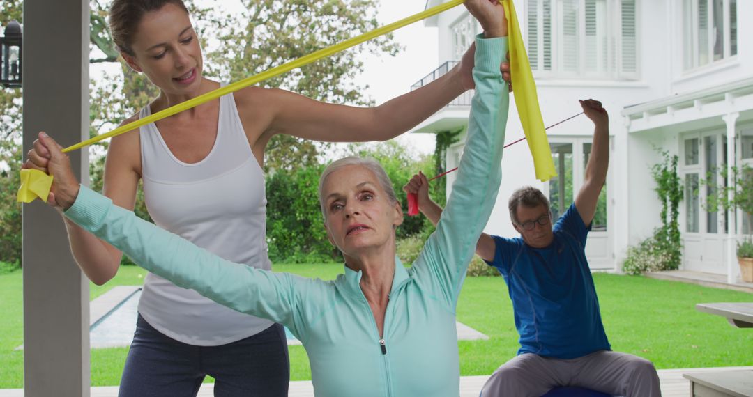 Senior Woman Exercising with Trainer Using Resistance Bands Outdoors - Free Images, Stock Photos and Pictures on Pikwizard.com