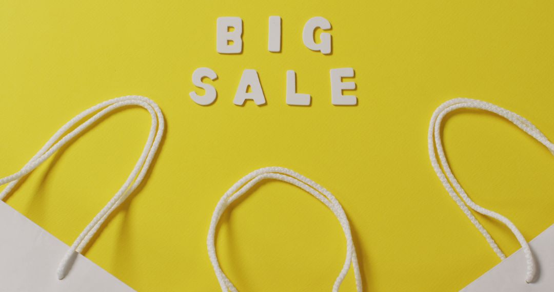 Big Sale Announcement with Shopping Bag Handles on Yellow Background - Free Images, Stock Photos and Pictures on Pikwizard.com
