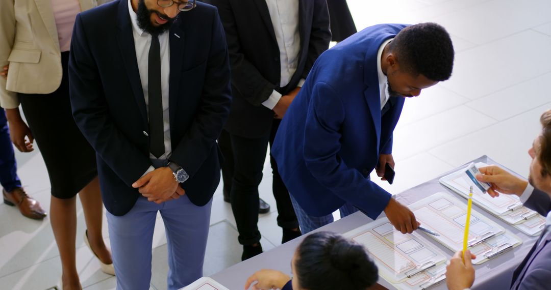 Business Professionals Queue at Conference Registration Table