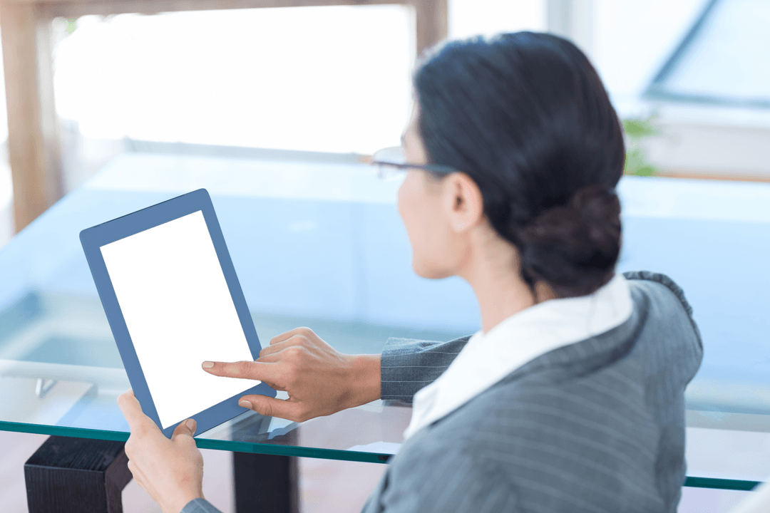 Businesswoman Interacting with Transparent Tablet at Desk