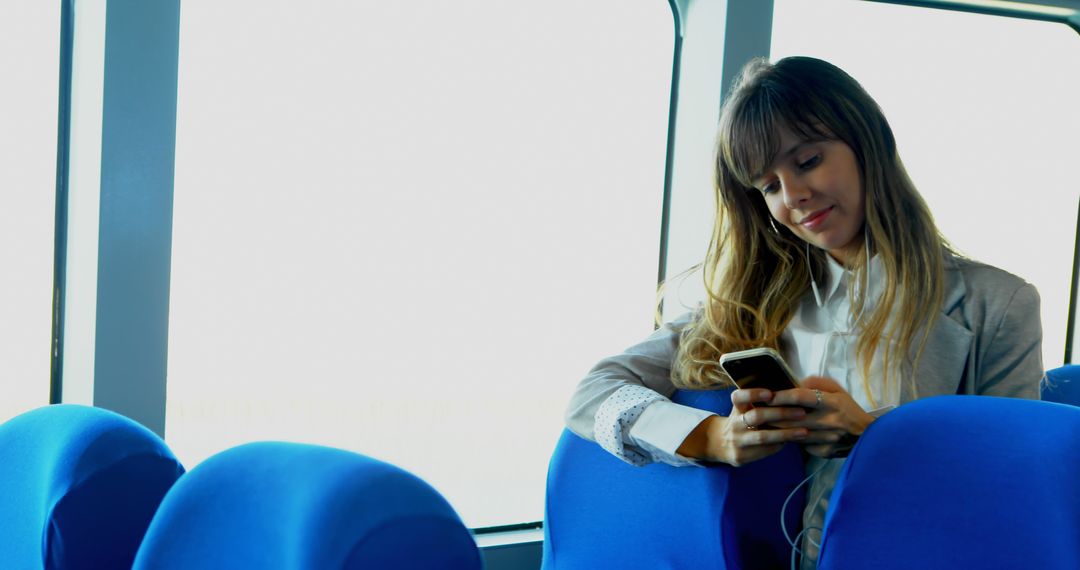 Young Woman Using Smartphone on Public Transport - Free Images, Stock Photos and Pictures on Pikwizard.com