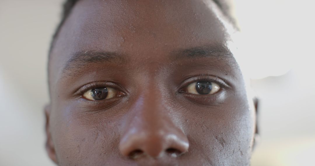 Close-up of Young African American Man's Face with Focused Eyes - Free Images, Stock Photos and Pictures on Pikwizard.com