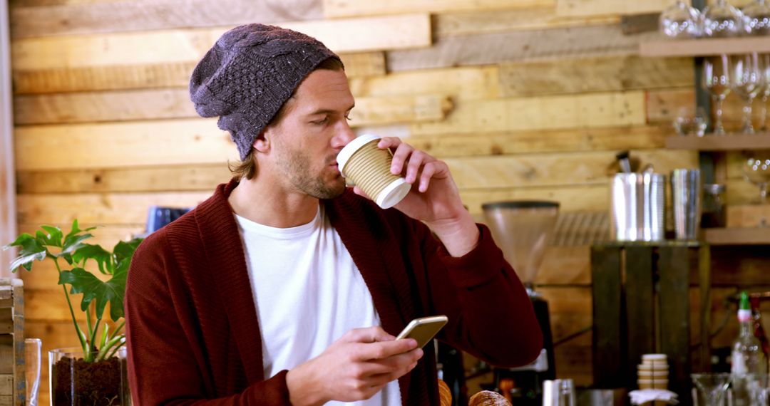 Casual Man Enjoying Coffee While Engaged with Smartphone - Free Images, Stock Photos and Pictures on Pikwizard.com