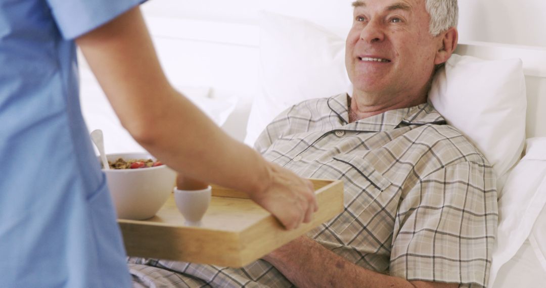 Senior Man Receiving Breakfast in Bed from Caregiver - Free Images, Stock Photos and Pictures on Pikwizard.com