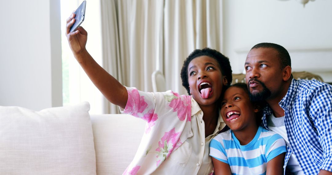 Joyful African American family taking selfie at home - Free Images, Stock Photos and Pictures on Pikwizard.com