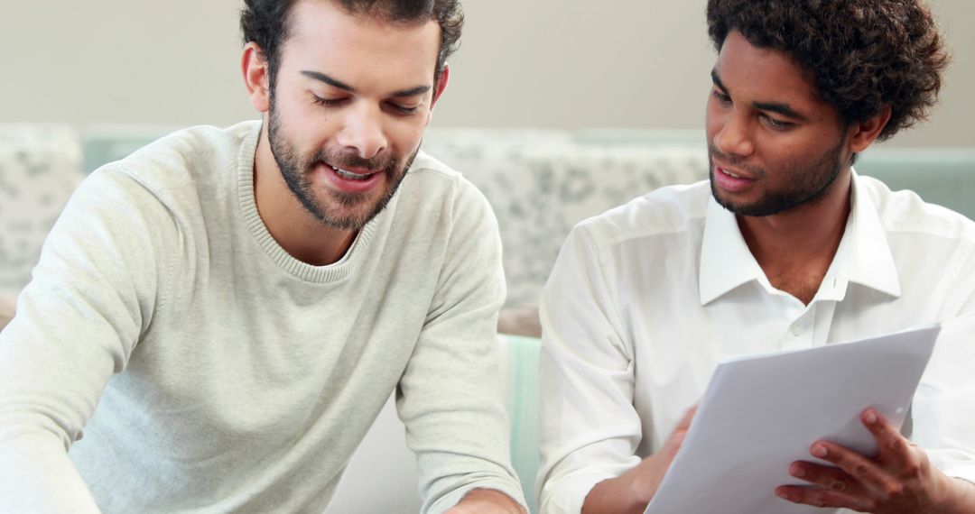 Collaborative Two Men Analyzing Document in Meeting