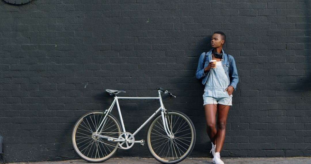 Young African American Woman Relaxing With Coffee and Bicycle - Free Images, Stock Photos and Pictures on Pikwizard.com