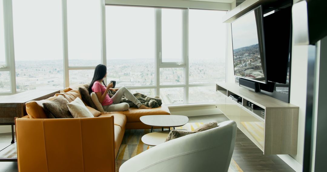 Woman Relaxing on Sofa with Pet Dog in Modern Living Room - Free Images, Stock Photos and Pictures on Pikwizard.com