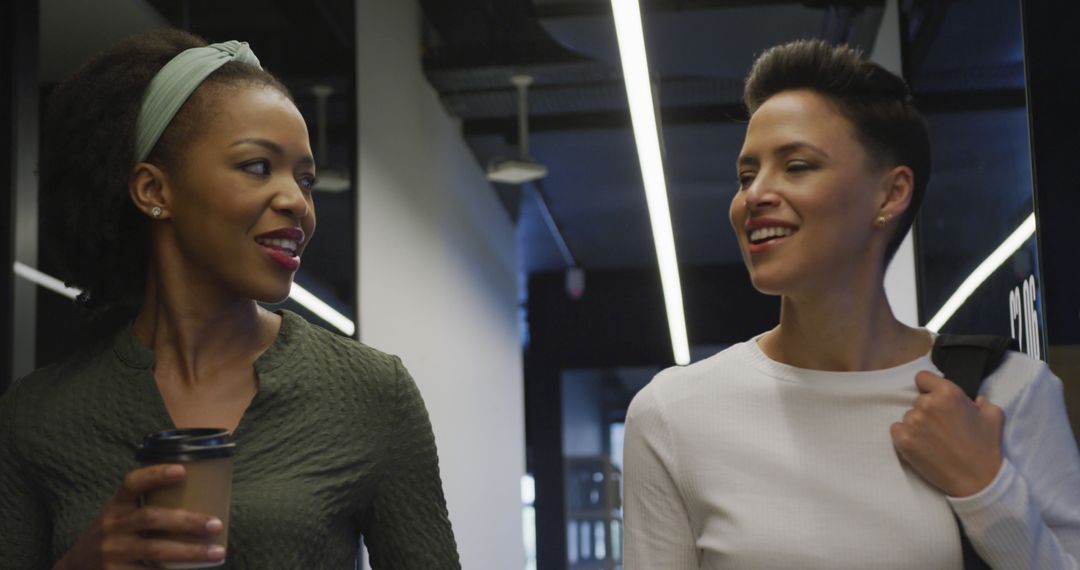 Smiling Multiracial Businesswomen Walking in Office Corridor - Free Images, Stock Photos and Pictures on Pikwizard.com