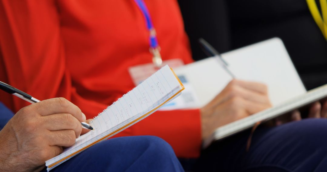 Midsection of Business Professionals Taking Seminar Notes