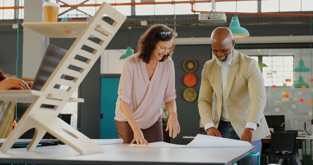 Designers Collaborating Over Project Plans in Modern Office