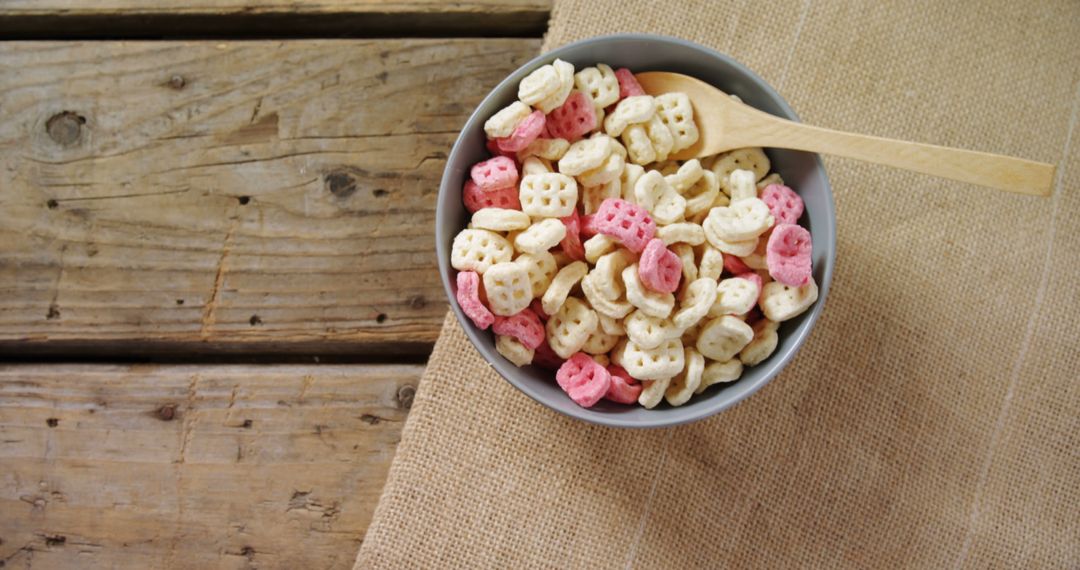 Bowl of Colorful Cereal on Wooden Table - Free Images, Stock Photos and Pictures on Pikwizard.com