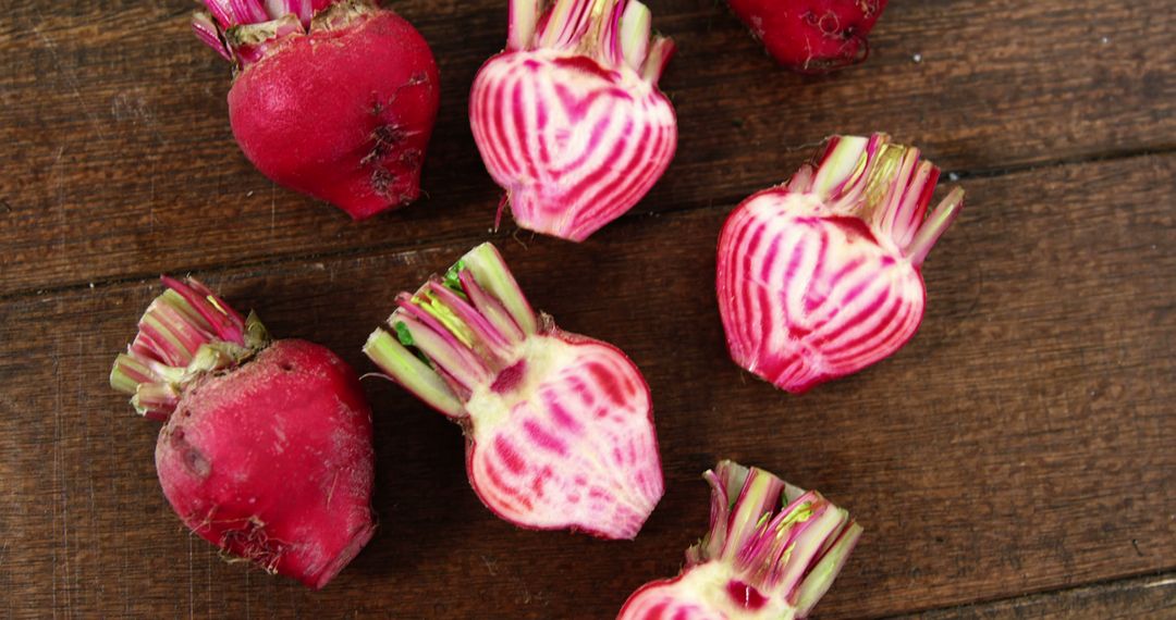 Freshly Cut and Whole Aesthetic Striped Beets on Rustic Wooden Background - Free Images, Stock Photos and Pictures on Pikwizard.com