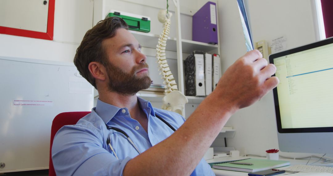 Caucasian Doctor Analyzing X-ray in Modern Office Setting