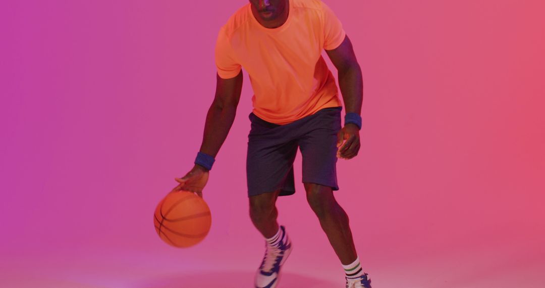 Athletic Man Dribbling Basketball in Studio under Neon Lights - Free Images, Stock Photos and Pictures on Pikwizard.com