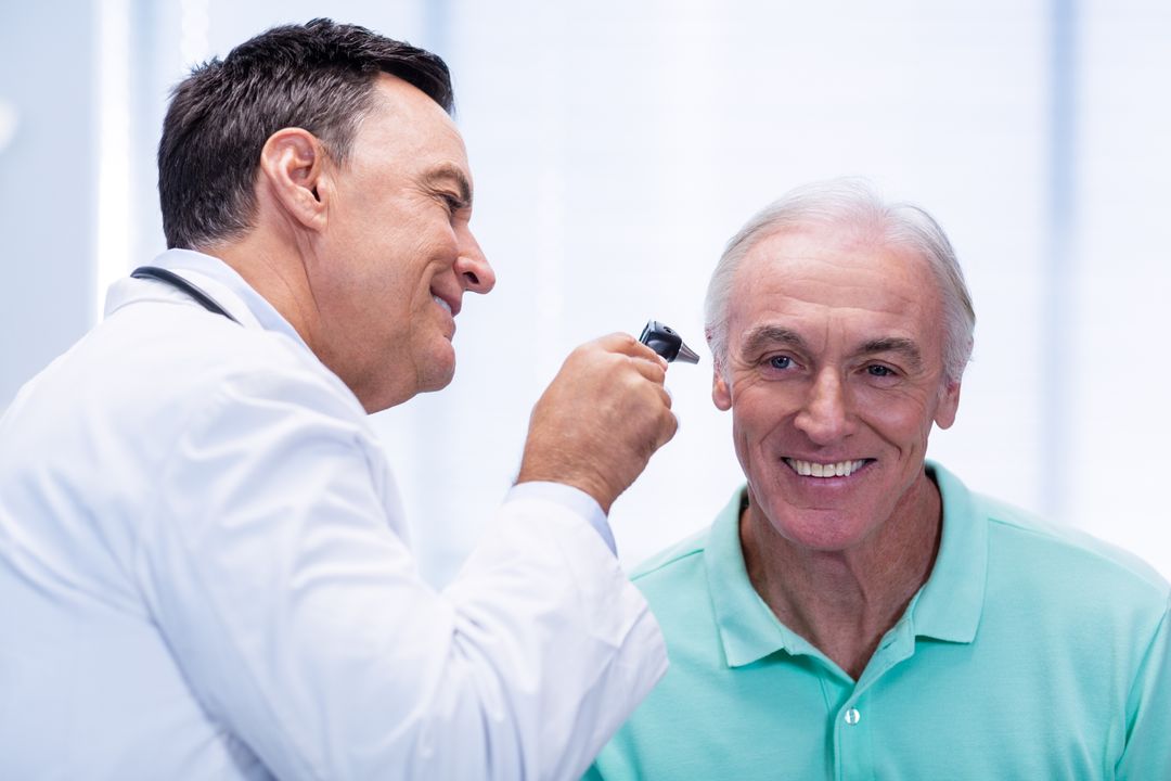 Doctor Examining Senior Patient's Ear with Otoscope - Free Images, Stock Photos and Pictures on Pikwizard.com