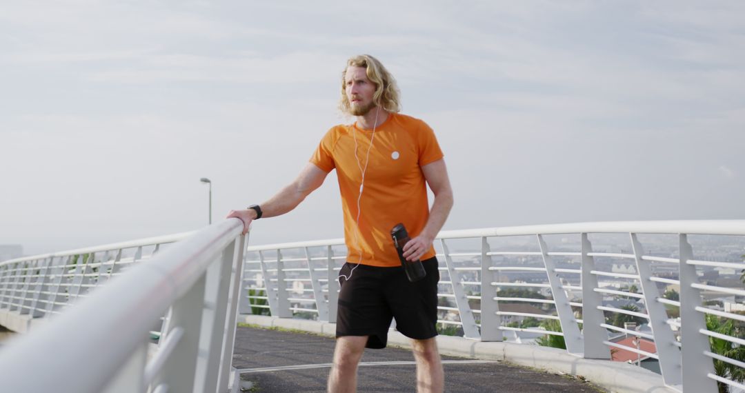 Active man jogging on urban bridge during morning workout - Free Images, Stock Photos and Pictures on Pikwizard.com