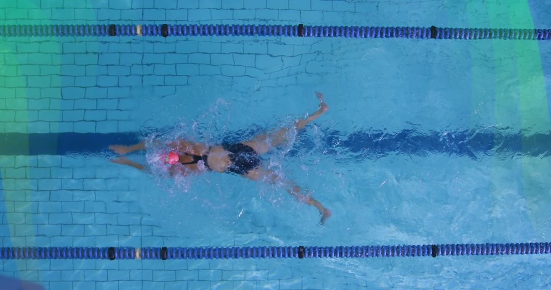 Female Athlete Exercising in Lap Pool with Pink Swim Cap