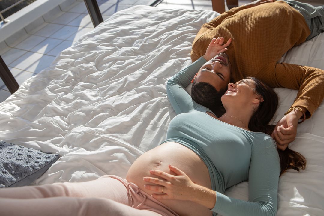 Couple Relaxing on Bed Gazing Happily Together Bonding