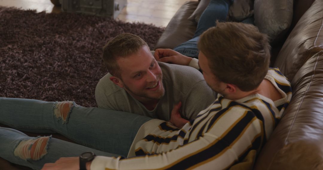 Joyful Gay Couple Relaxing and Communicating on Couch