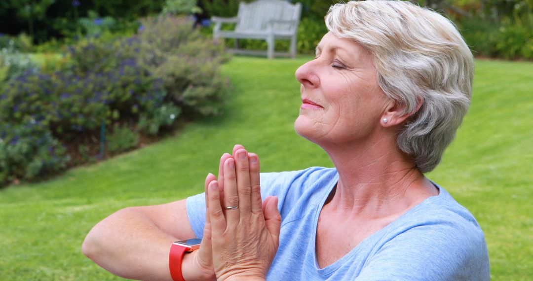 Senior Woman Meditating Outdoors with Eyes Closed in Sunny Garden - Free Images, Stock Photos and Pictures on Pikwizard.com