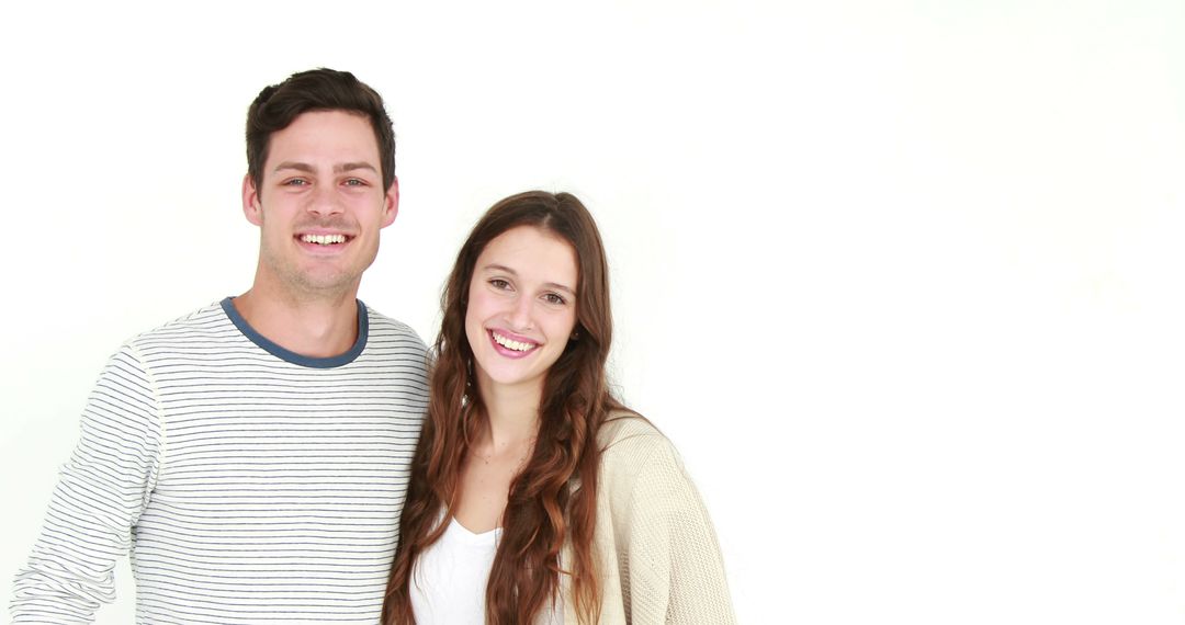 Smiling Young Couple Posing Against White Background Photography - Free Images, Stock Photos and Pictures on Pikwizard.com