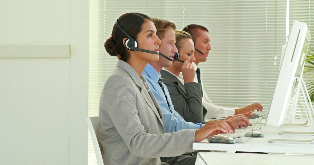 Focused Customer Service Representatives Wearing Headsets in Office - Free Images, Stock Photos and Pictures on Pikwizard.com