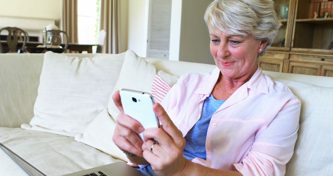 Senior Woman Smiling While Using Smartphone at Home - Free Images, Stock Photos and Pictures on Pikwizard.com