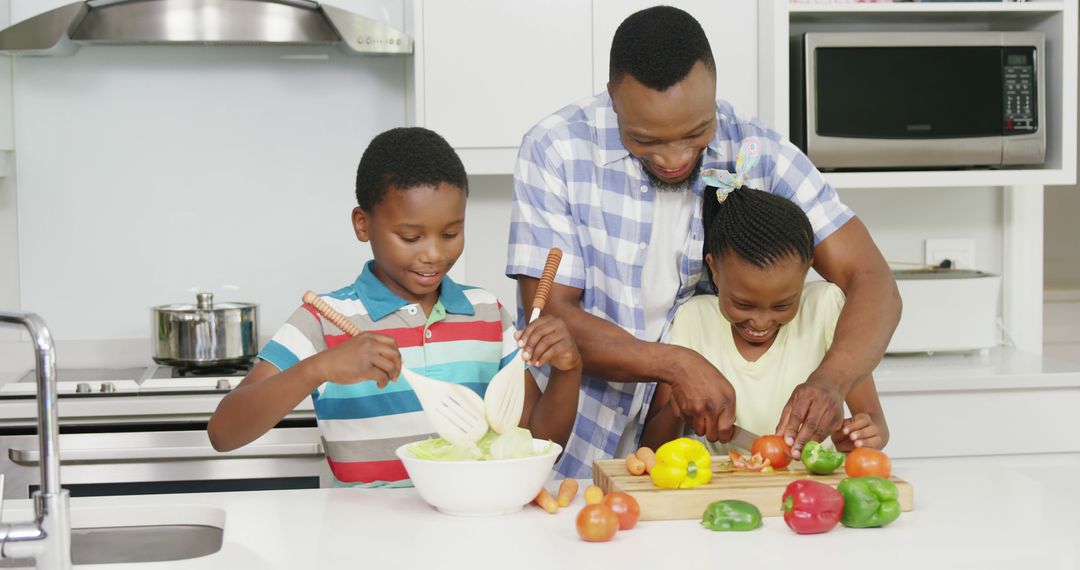 African American Family Cooking Together in Modern Kitchen - Free Images, Stock Photos and Pictures on Pikwizard.com