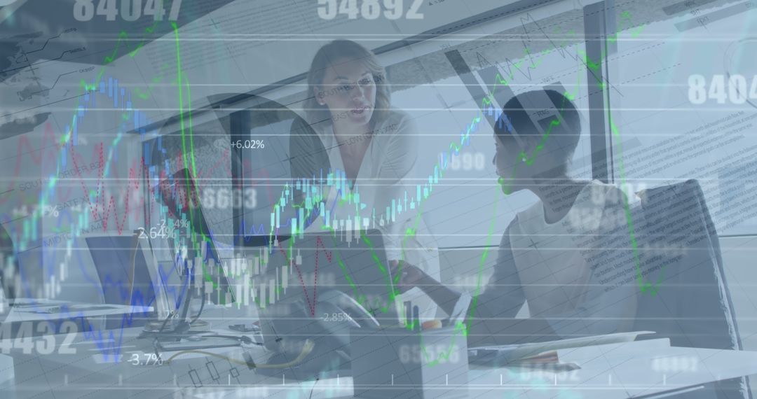 Collaborative Businesswomen Analyzing Financial Data in Office