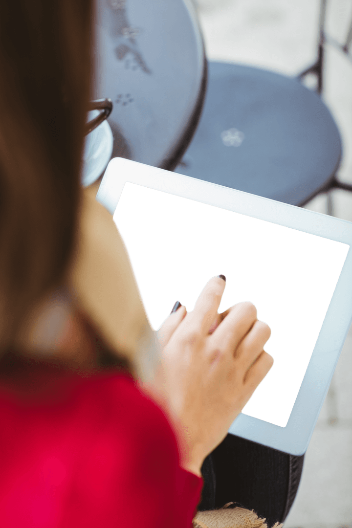 Woman Using Transparent Tablet with Blank Screen in Outdoor Cafe