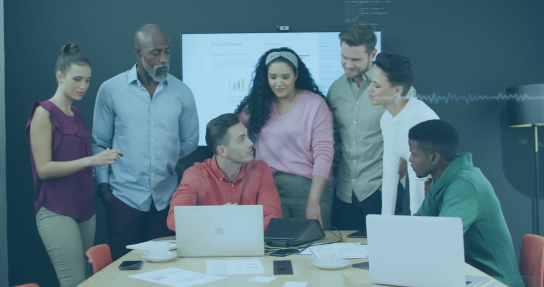 Diverse Team Collaborating Over Business Presentation with Data Insights