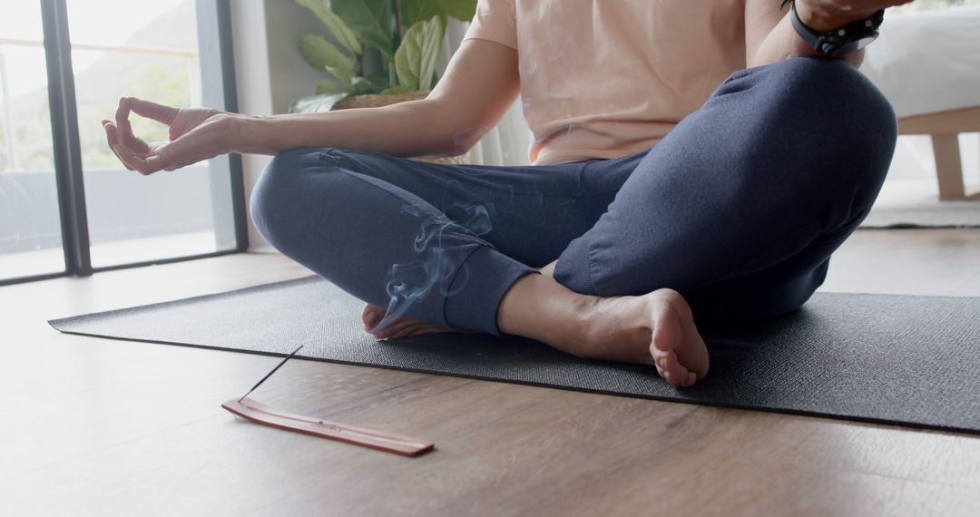 Person Meditating on Floor Mat with Burning Incense Stick Indoors - Free Images, Stock Photos and Pictures on Pikwizard.com