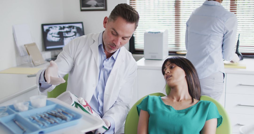 Dentist Explaining Procedure to Patient in Clinic Exam Room - Free Images, Stock Photos and Pictures on Pikwizard.com